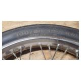 Used CS Hi-Max 100/90-19 57H Front Motorcycle Tire mounted on a spoked chrome rim w/brake plate