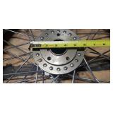 New Dunlop D404F 100/90-19 M/C 57H Front Motorcycle Tire mounted on a spoked chrome rim