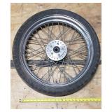 Used Bridgestone Spitfire 11F 90/90/19 52H Front Motorcycle Tire mounted on a spoked chrome rim