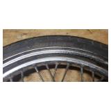 Used Bridgestone Spitfire 11F 90/90/19 52H Front Motorcycle Tire mounted on a spoked chrome rim