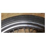 Used Bridgestone Spitfire 11F 90/90/19 52H Front Motorcycle Tire mounted on a spoked chrome rim