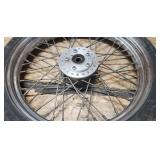 Used Bridgestone Spitfire 11F 90/90/19 52H Front Motorcycle Tire mounted on a spoked chrome rim