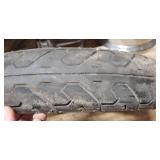 Used Bridgestone Spitfire 11F 90/90/19 52H Front Motorcycle Tire mounted on a spoked chrome rim