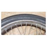 Used Cheng Shin 2.75 - 17 4 ply Front Motorcycle Tire mounted on a spoked chrome rim