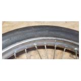 Used Cheng Shin 2.75 - 17 4 ply Front Motorcycle Tire mounted on a spoked chrome rim
