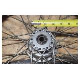 Used Cheng Shin 2.75 - 17 4 ply Front Motorcycle Tire mounted on a spoked chrome rim