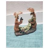 Deer taking pictures of a Hunter they caught figurine