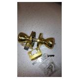 Kwikset Tylo Hall/Closet Passage Door Knob in Polished Brass