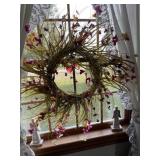 Wreath, figurines, glass butterfly in window