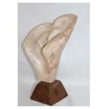 Hand carved rose stone sculpture on wooden base