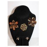 Three vintage brooches. one pair of earrings.