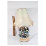 Small glass lamp filled with glass marbles