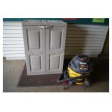 Medium garage cabinet and a shop Vac