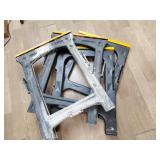 Four plastic foldable saw horses
