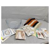 Glass bowl, sewing patterns and small rug