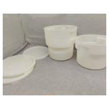 3 medium sized plastic containers all have lids