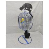 Birdcage with cats on it
