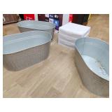 Three metal planters and plastic storage