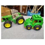 Two plastic John Deere toys