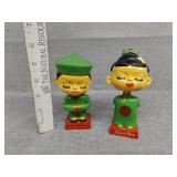 Two Oriental bobbleheads