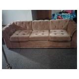Hide-a-bed couch, gold color.