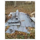 Pile of tin barn roof, some damaged, some good