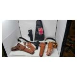 Pistol holsters and cases.