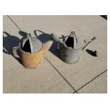 Two water sprinkle cans