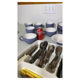 Blue set of kitchen dishes and silverware
