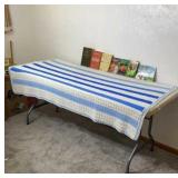 Crocheted blue and white Afghan, books,