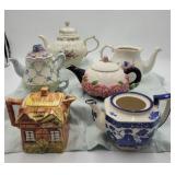 LOT OF TEA POTS. SOME WITH CHIPS