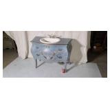 Bombay style lavatory with drawer on legs.