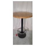 Round oak 30" bar height table w/ foot rest.