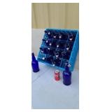 16 blue resealable bottles with plastic tray.
