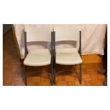 2 white folding chairs