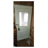 Old house door and ornate wood screen door