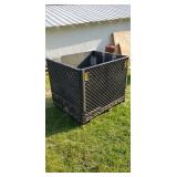 Plastic crate on plastic skid sides fold down.