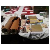 Two large rolls of sandpaper and other sandpaper