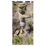 Concrete statue, legs are broken off, used to be