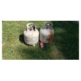 Two new style propane bottles one full.