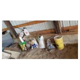 Two  garden sprayers potting soil  next