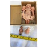 Vintage Kewpie doll in pink crocheted clothes,