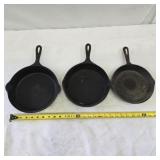 Three cast iron pans