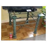 Glass top table with medal base.