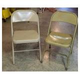 Two metal folding chairs