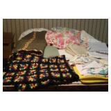 Contents on bed, bedding Afghan, towels ,pillow