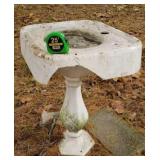 Old cast iron sink base used as birdbath broke