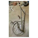 Old garden steel wheel push plow.