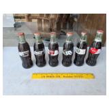 Six Different Unopened Coke Bottles,
