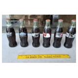 Six Different Commemorative Coke Bottles Unopened